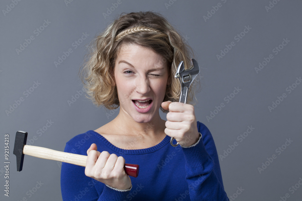 winking independent girl playing with tools like DIY toys winking independent girl playing with tools like DIY toys