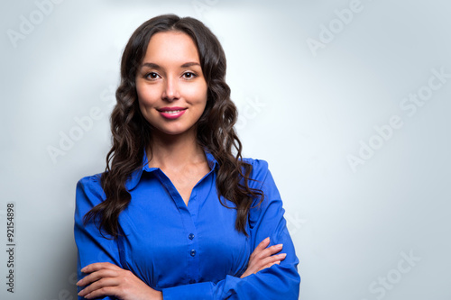 Smiling business woman blue suit dressed standing against white
