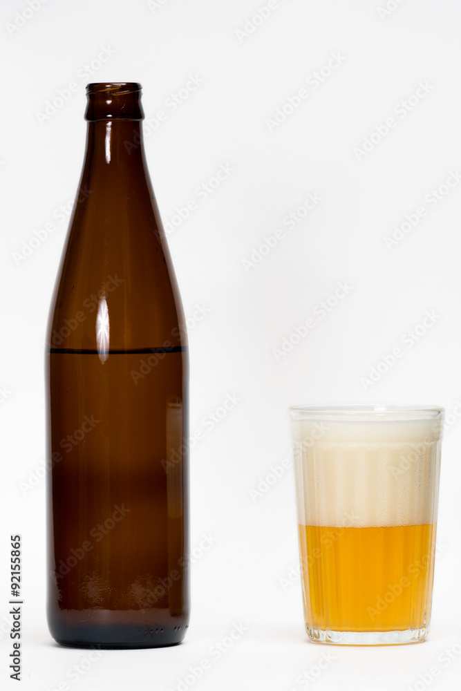 opened beer bottle and half glass