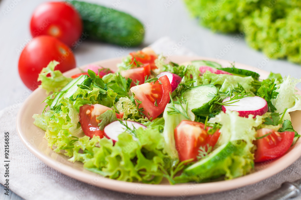 Tomato and cucumber salad with lettuce leafes Tomato and cucumber salad with lettuce leafes