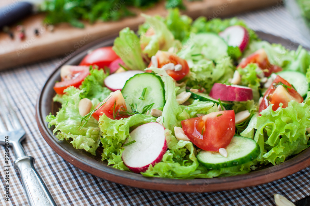 Tomato and cucumber salad with lettuce leafes Tomato and cucumber salad with lettuce leafes