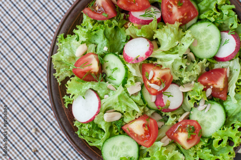 Tomato and cucumber salad with lettuce leafes Tomato and cucumber salad with lettuce leafes