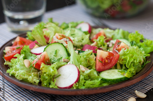 Tomato and cucumber salad with lettuce leafes