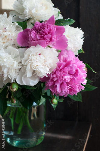 white and pink peonies on wooden background