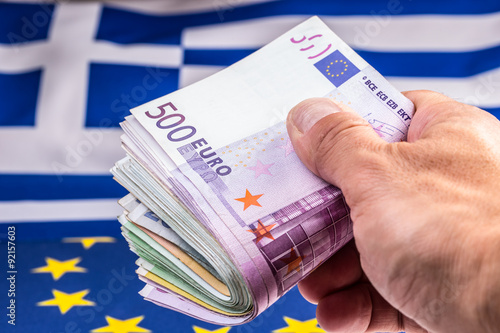 Euro coins. Euro currency. Euro money. Greece and european  flag and euro money.  Coins and banknotes European currency freely laid on the European flag