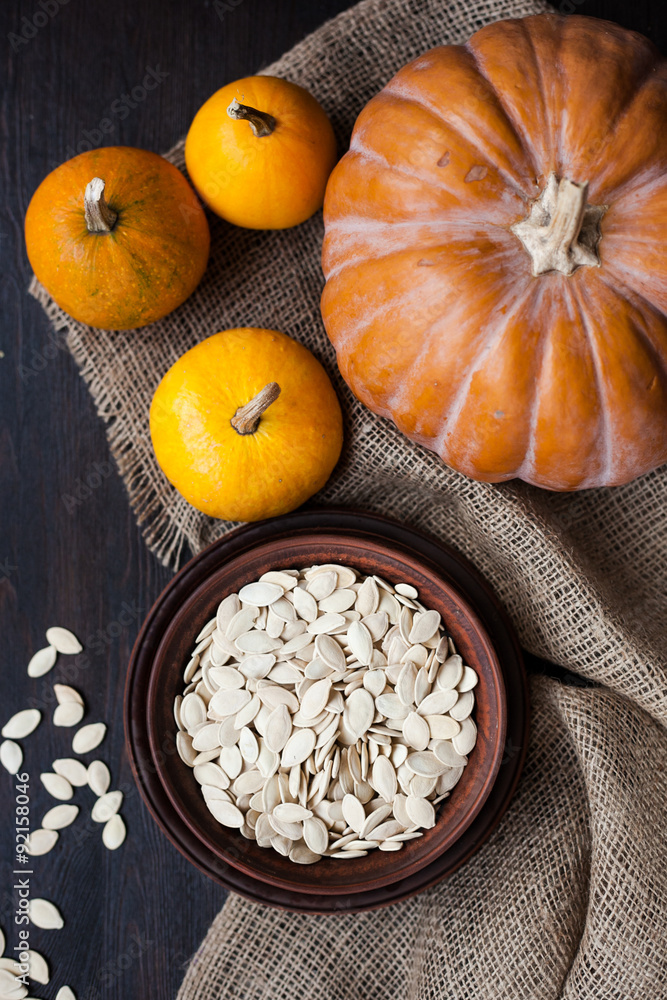 Bowl with toasted pumpkin seeds and wooden spoon Bowl with toasted pumpkin seeds and wooden spoon