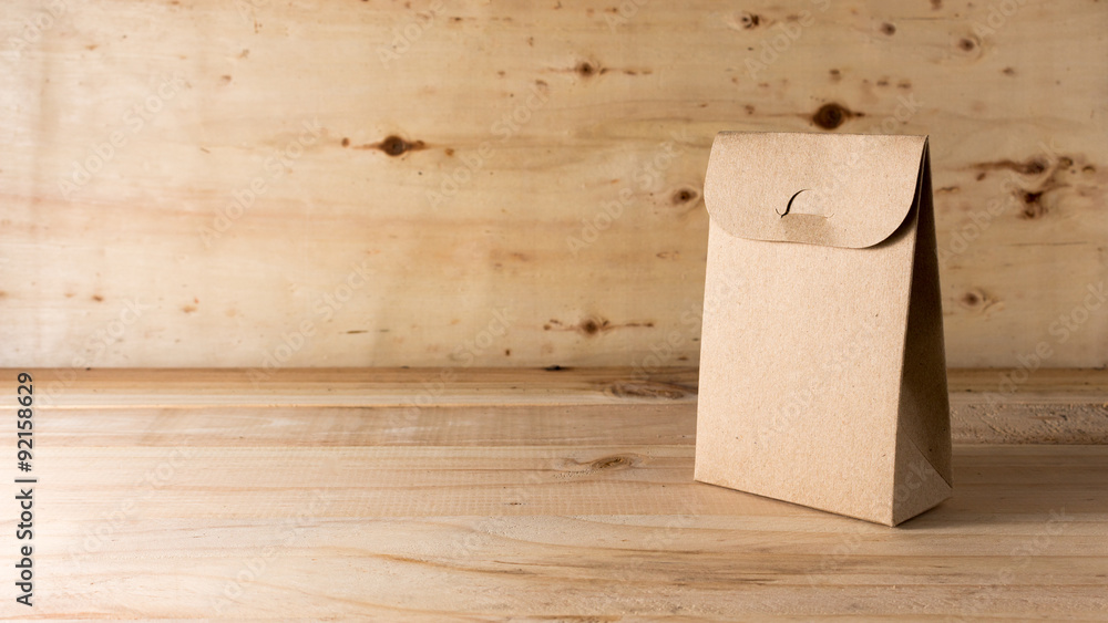 Fototapeta premium paper bag on wooden background