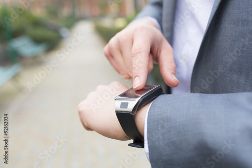 Man using  a smartwatch. close-up hands..