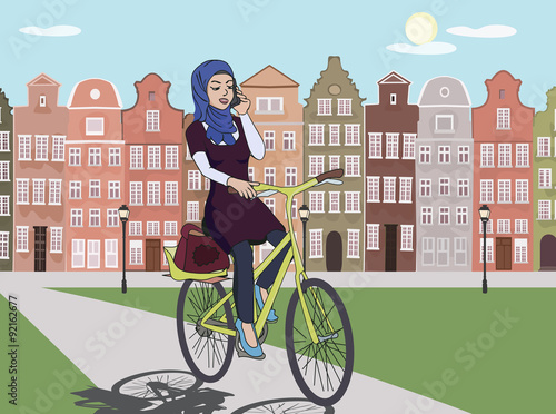 arabic girl riding bicyle at europe city landscape