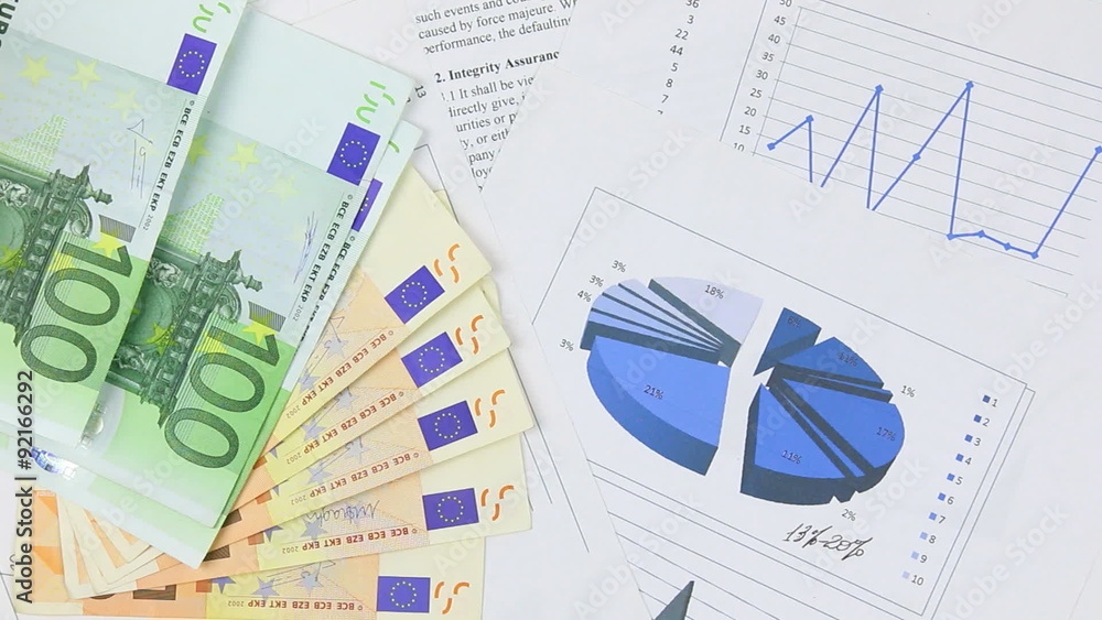 Businessman thinks euro on the table with chart Businessman thinks euro on the table with chart