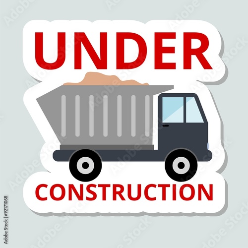 Truck with sand under construction sticker