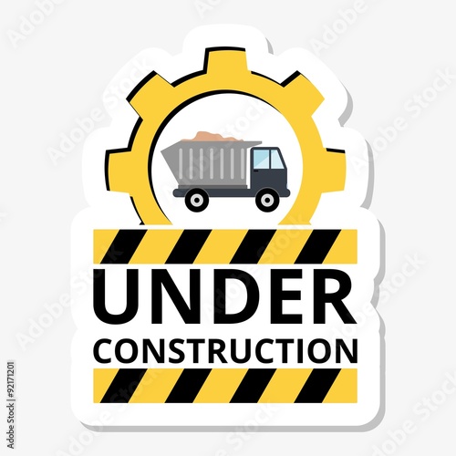 Truck with sand under construction sign