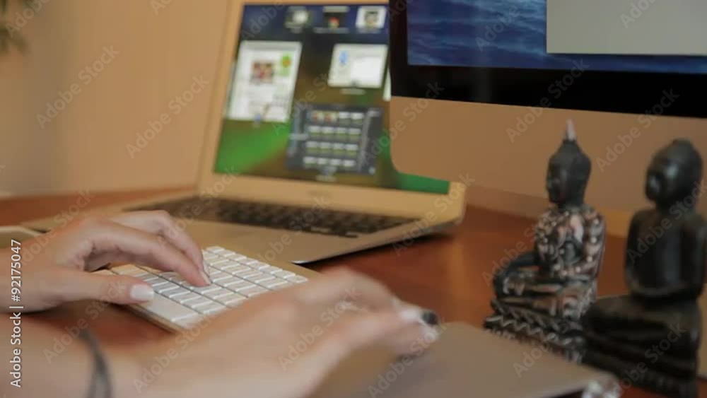 Side view with depth and perspective blur of designer working at a wooden desk. Part of my hipster designer working at office or agency series. Side view with depth and perspective blur of designer working at a wooden desk. Part of my hipster designer working at office or agency series.