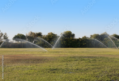 Pouring water of green lawn.design.landscape.Wet grass photo