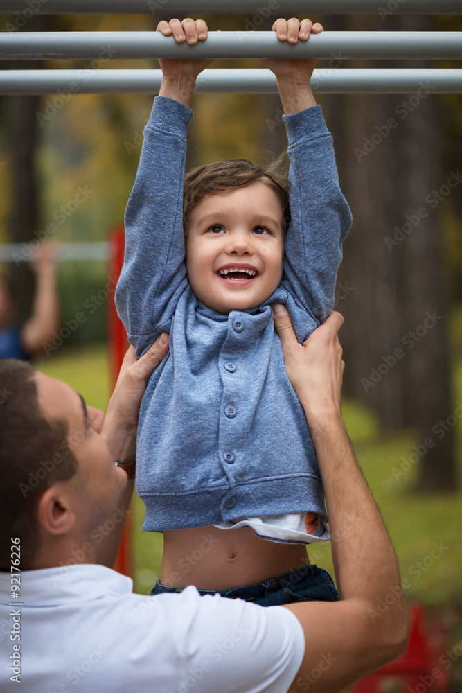 Happy father and son having fun in autumn parkHappy father and son having fun in autumn park Happy father and son having fun in autumn parkHappy father and son having fun in autumn park