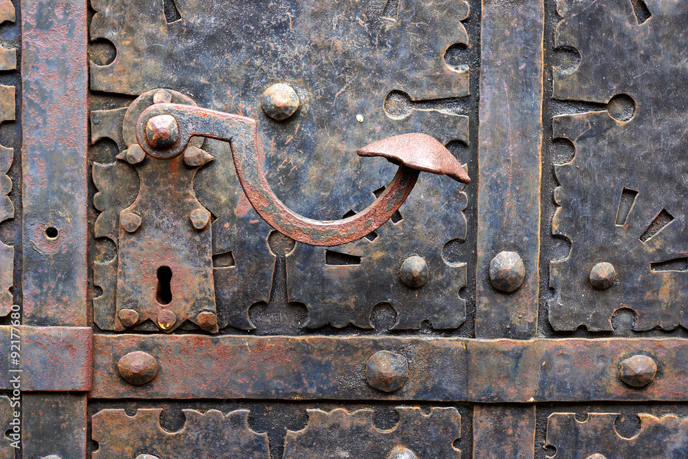 Old door handle on iron medieval door in Gdansk, Poland.