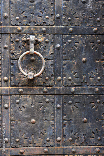 Old door handle on iron medieval door in Gdansk, Poland. #92177688
