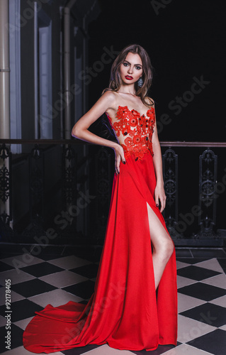 Fashion portrait of young sexy woman in red dress