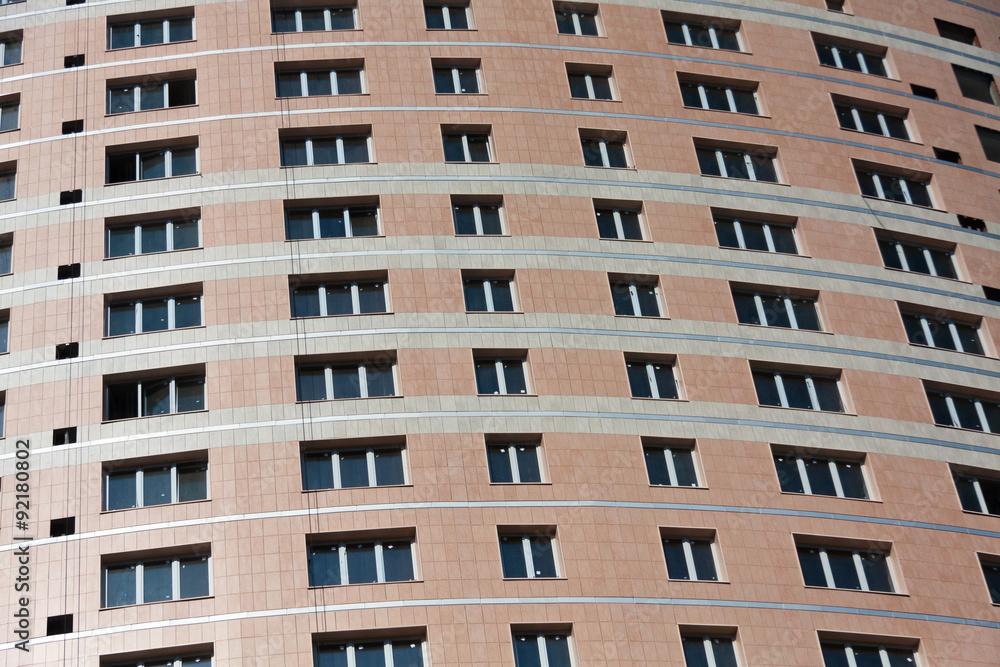 A lot of windows on the brown wall