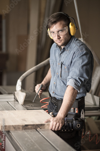 Worker in earmuffs and goggles