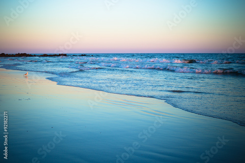 Beautiful ocean shoreline at beach at sunset © littleny