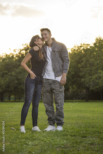 Brother and sister, portrait. Backlit from sunset.