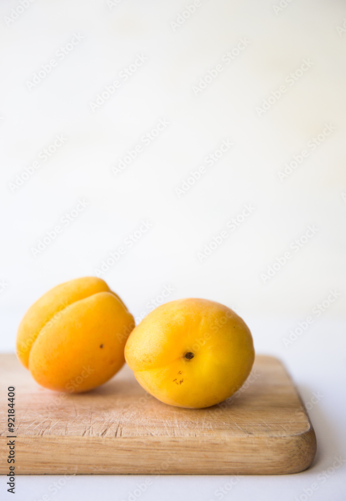apricots on a bamboo cutting board