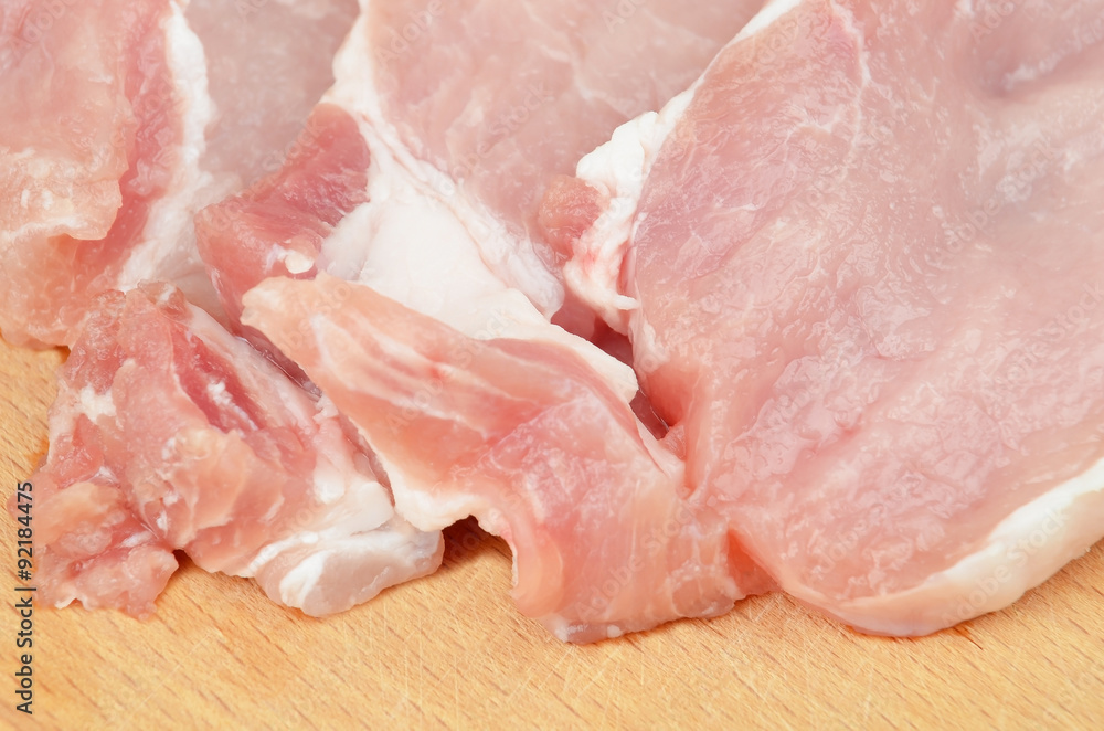 Raw meat steaks on wooden board background, DOF Raw meat steaks on wooden board background, DOF