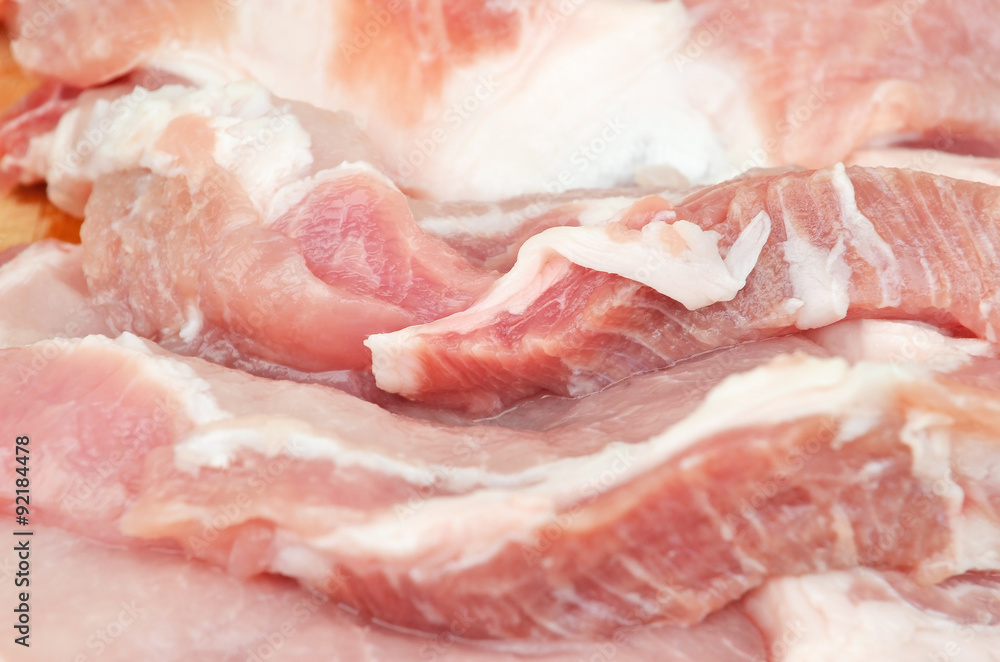 Raw pork meat sliced on steak portion Raw pork meat sliced on steak portion