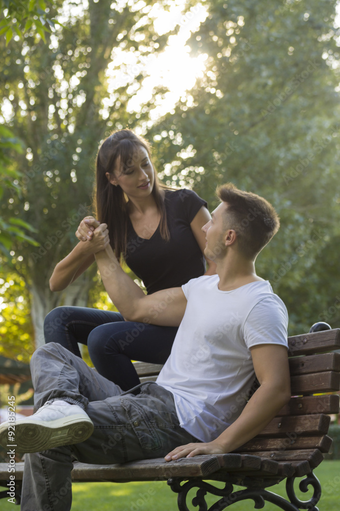 Brother and sister, sitting on bench at park. young in 20s. Brother and sister, sitting on bench at park. young in 20s.