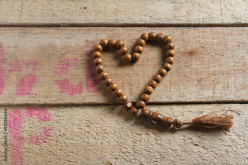 tasbih (moslem prayer beads) at wooden board tasbih (moslem prayer beads) at wooden board