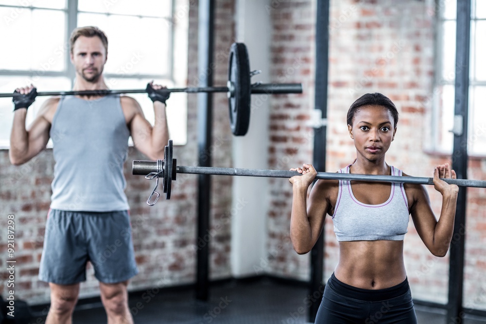 Fit couple lifting weight together Fit couple lifting weight together