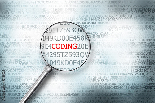 reading coding on computer screen with a magnifying glass photo