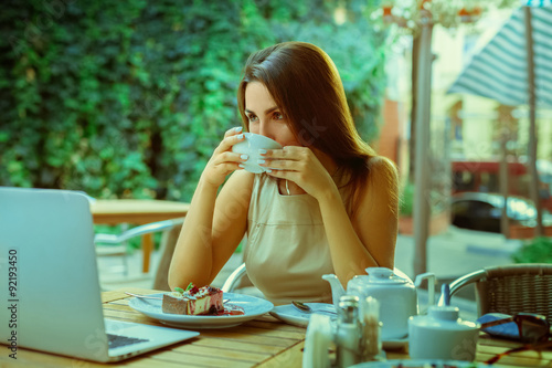 Portrait of sexy young woman drink tea from white cup and lookin