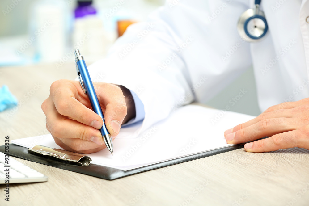 Doctor working at table in office Doctor working at table in office