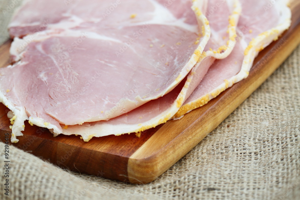 Ham slices wooden chopping board hessian.
Slices of boiled ham on a wooden chopping board. Ham slices wooden chopping board hessian.
Slices of boiled ham on a wooden chopping board.