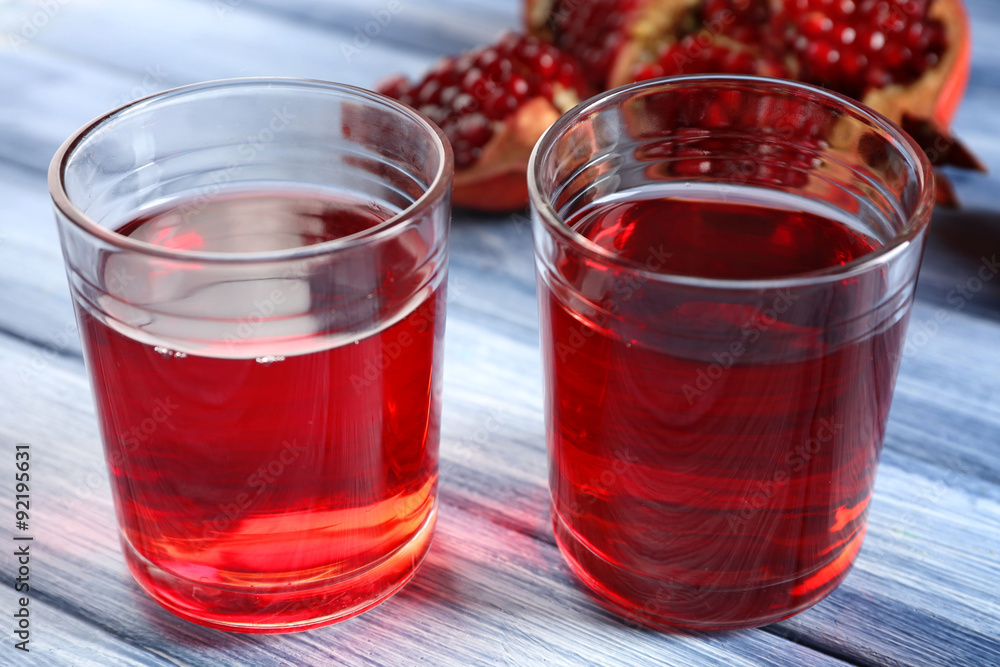 Fresh garnet juice with fruit on table close up Fresh garnet juice with fruit on table close up