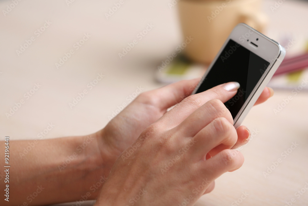 Woman using mobile phone on workplace close up Woman using mobile phone on workplace close up