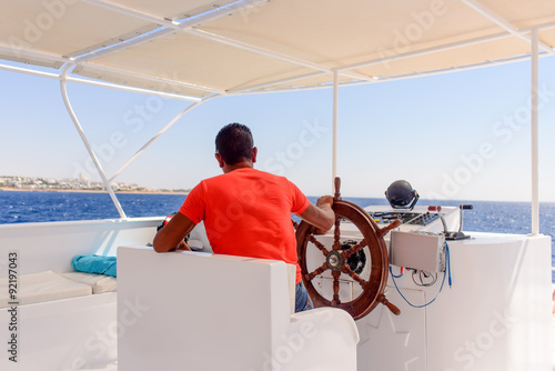 Captain or helmsman on a yacht