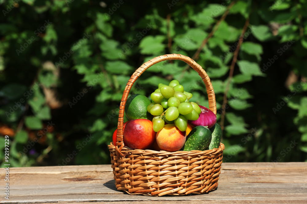 Heap of fresh fruits and vegetables in basket on table outdoors Heap of fresh fruits and vegetables in basket on table outdoors