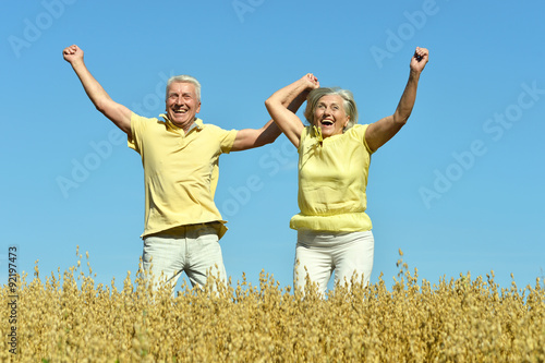 Loving mature couple in field