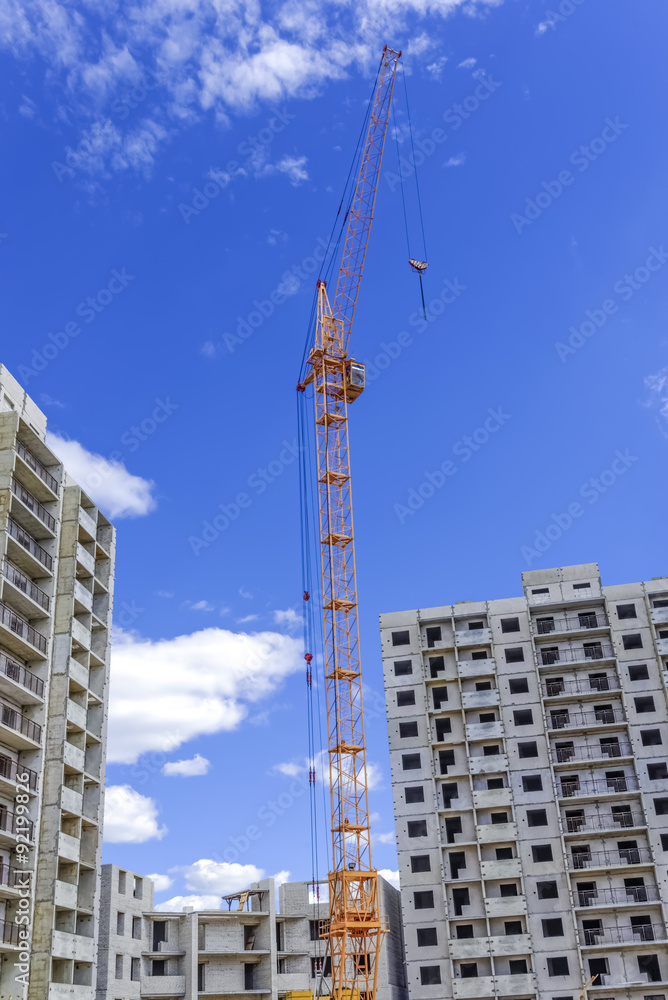 Fototapeta premium Building multistorey houses and hoisting tower cranes
