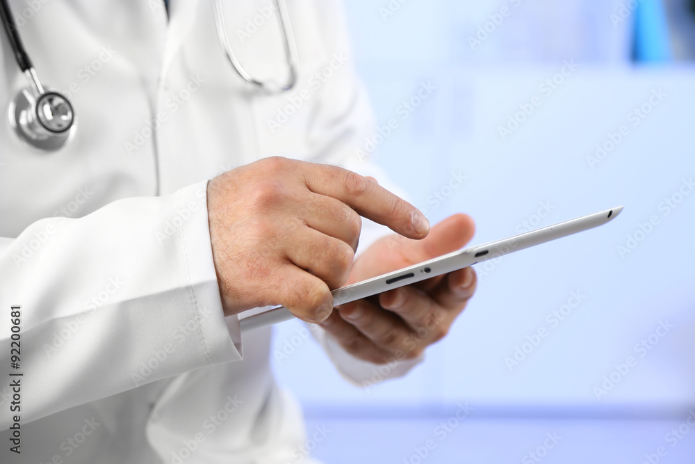 Doctor with digital tablet at his workplace Doctor with digital tablet at his workplace