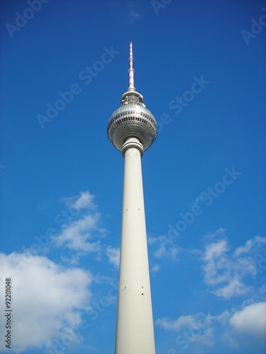 Famous Berlin TV tower located in the center of the city on Alexanderplatz, on a sunny day, against clear blue sky.