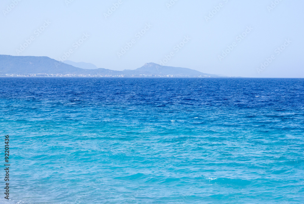 summer sea on an island on the background of rocks summer sea on an island on the background of rocks