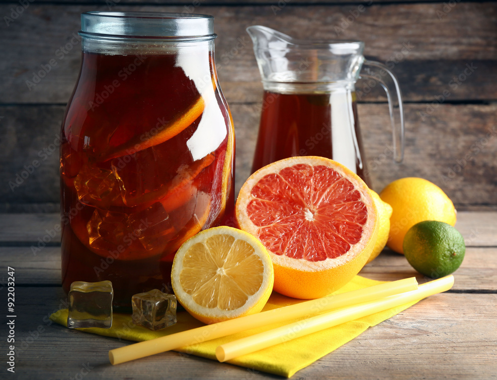 Iced tea with lemon and grapefruit on wooden background Iced tea with lemon and grapefruit on wooden background