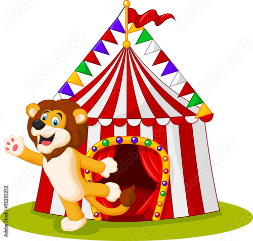 Fototapeta Naklejka Na Ścianę i Meble -  Cute lion waving hand in the front of circus tent
