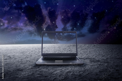 Fotografie Big laptop on the outer space