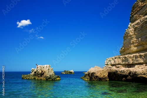 blue sky leaving for horizon above a blue surface of the sea