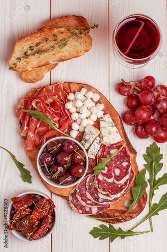 Wine snack set. Variety of cheese and meat, olives, grapes, arug